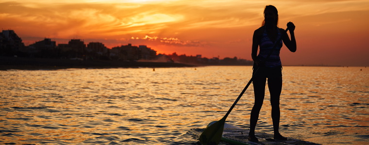 young woman paddleboarding