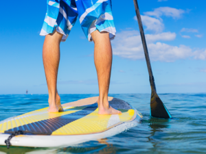 Man on Stand Up Paddle Board, SUP, in the Waters off Hawaii