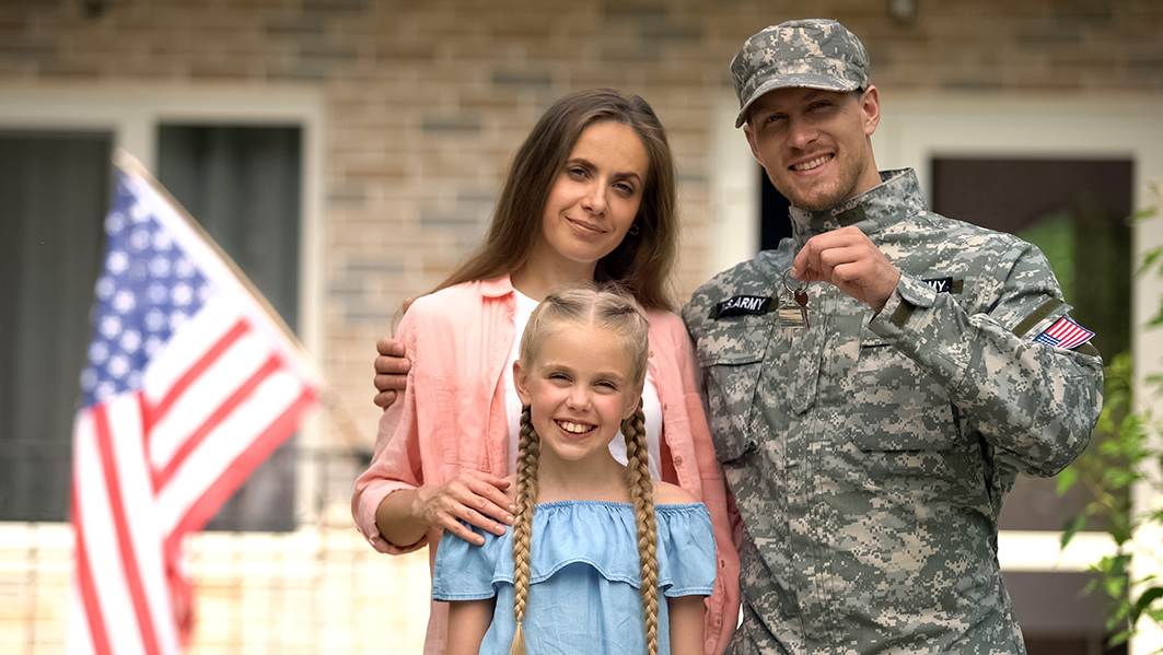 US military man with family showing keys from house